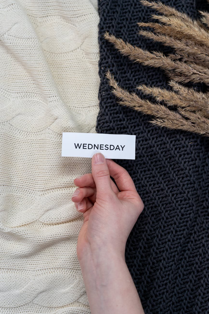 person holding white and black card